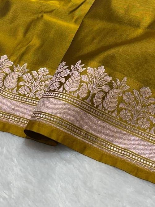 Olive green banarasi Mashru Katan Silk Saree featuring zari butti work and heavy woven pallu.