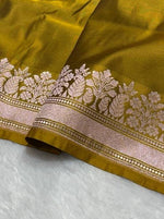 Olive green banarasi Mashru Katan Silk Saree featuring zari butti work and heavy woven pallu.