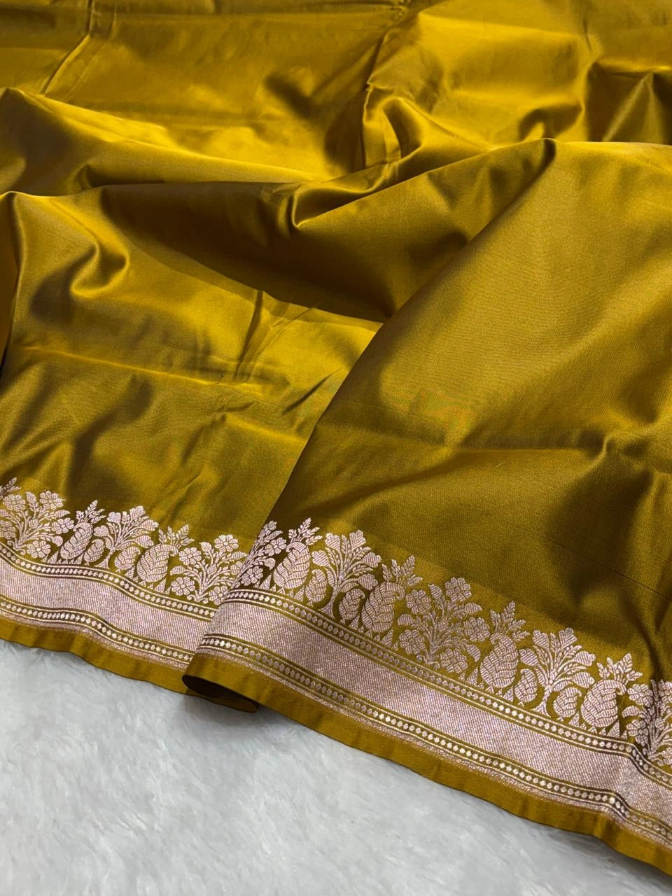 Olive green banarasi Mashru Katan Silk Saree featuring zari butti work and heavy woven pallu.