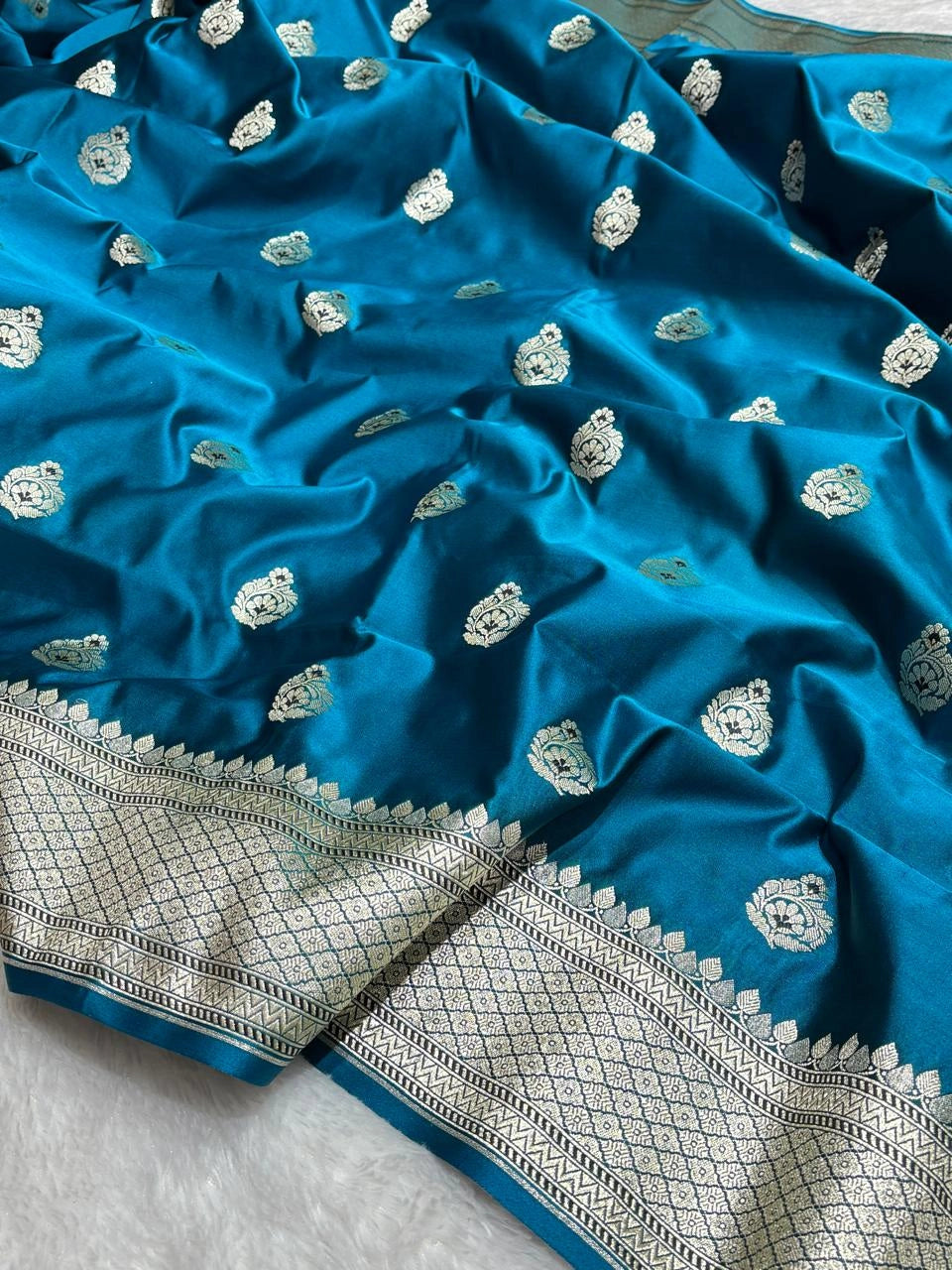 Peacock Blue banarasi Mashru Katan Silk Saree featuring zari butti work and heavy woven pallu.